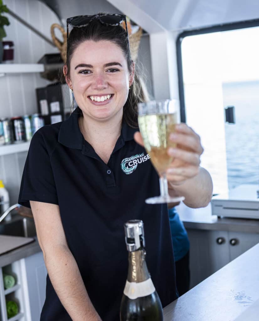 Crew member serving sparkling wine